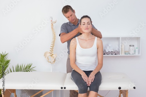 Doctor doing neck adjustment photo