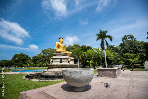 Beautiful landscape and golden buddha statue in Viharamahadevi Park, Colombo, SriLanka photo