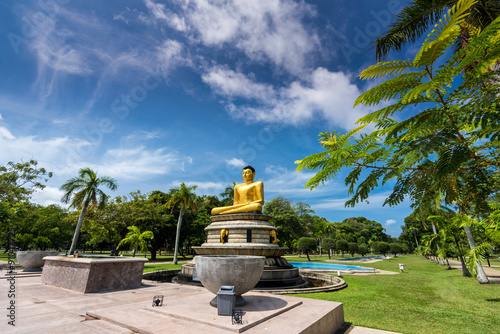 Beautiful landscape and golden buddha statue in Viharamahadevi Park, Colombo, SriLanka photo