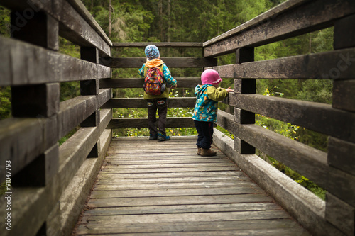 two children standing on view platform and watching waterfall in Krimm