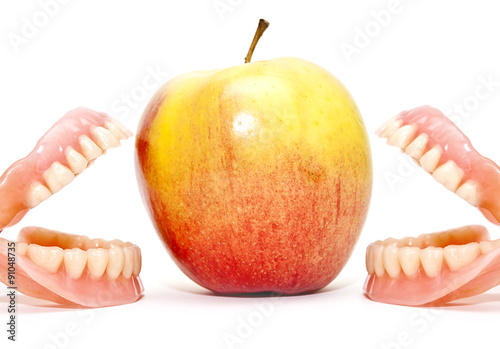 Two false teeth and an apple