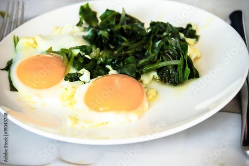 Creamy spinach with fried egg. Healthy breakfast