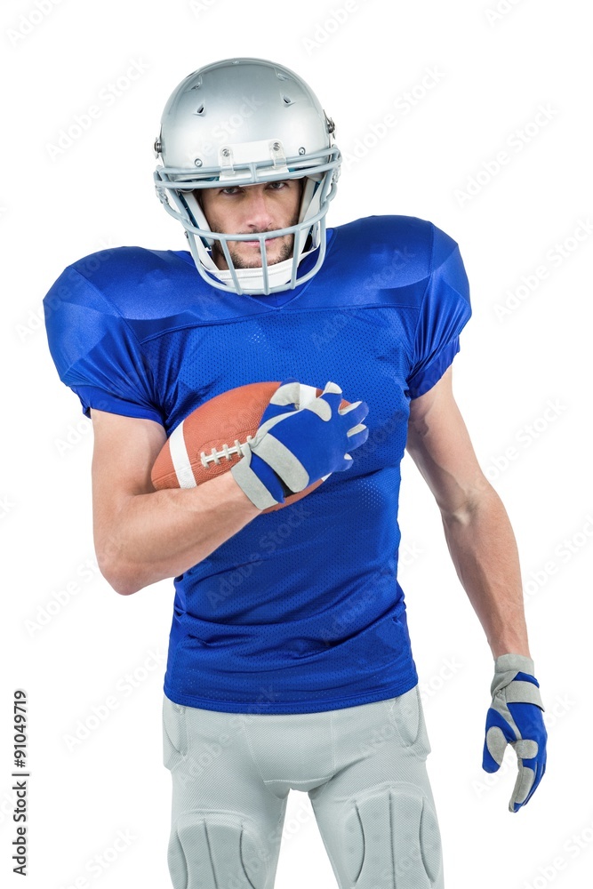 Portrait of confident American football player holding ball