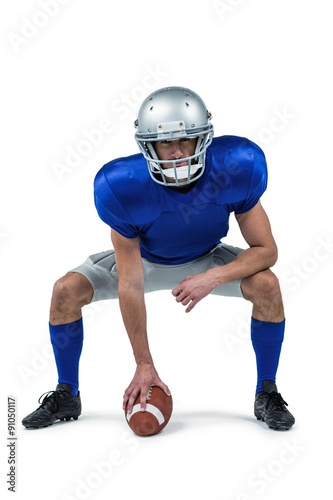 American football player placing ball