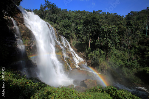 Powerful stream waterfall in rainforest with rainbow, Chiang Mai