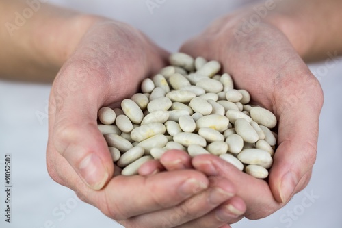 Woman showing handful of lima beans