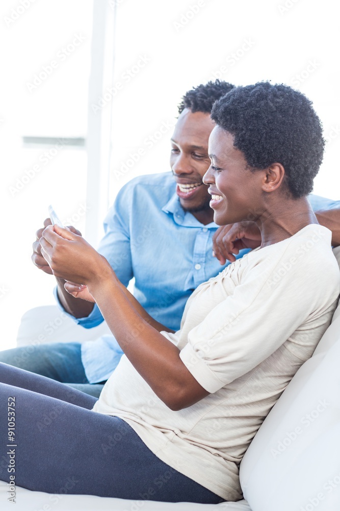 Fototapeta premium Couple smiling while looking at photo