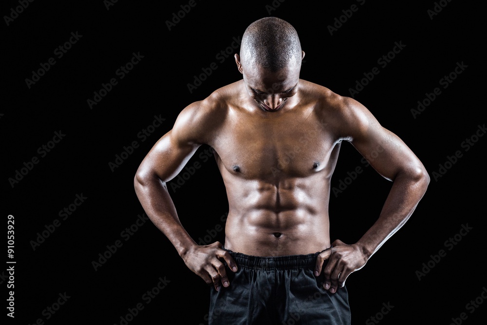 Fototapeta premium Muscular man with hand on hip looking down