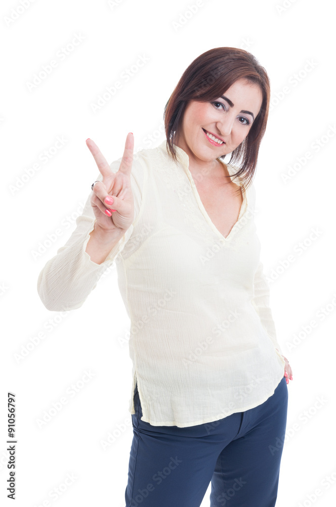 Casual woman showing victory or peace gesture and smiling Casual woman showing victory or peace gesture and smiling