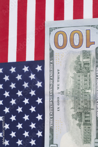One hundred Dollar bill on American flag