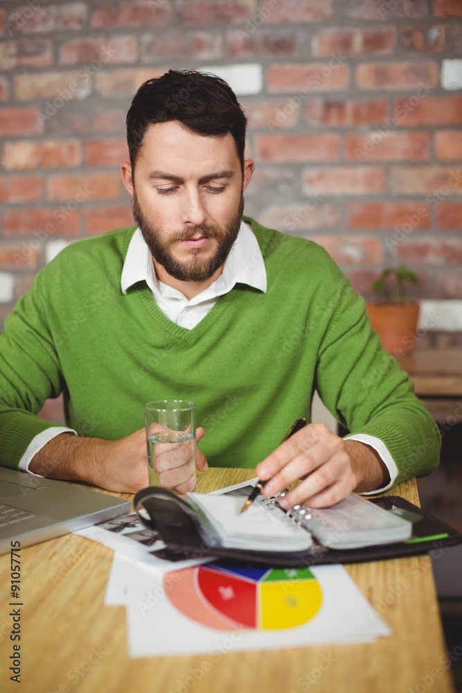 Businessman writing in diary Businessman writing in diary