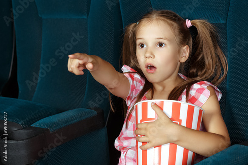 Little girl pointing to screen during film
