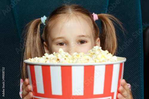 Adorable little girl with popcorn