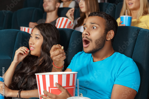 Young man watching a movie with admiration