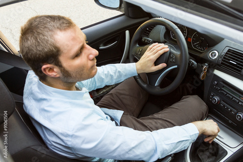 Young businessman driving his car