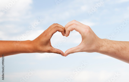 woman and man hands showing heart shape