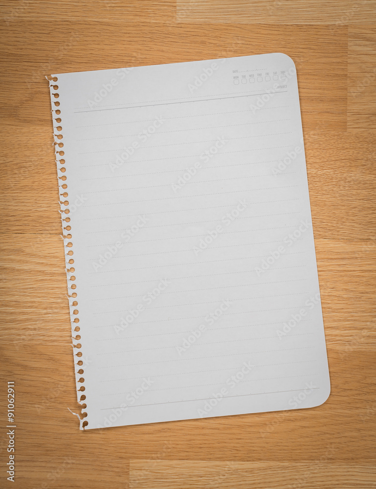 White note book paper on wooden desk