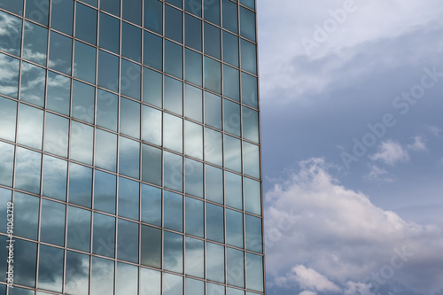 Modern Building Glass Facade Reflecting Cloudy Blue Sky