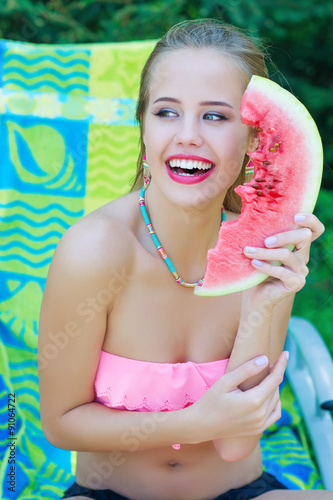 Summertime. Beautiful woman portrait with watermelon slice
