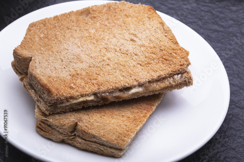 Kaya Toast (Asia Snack) on the white dish and table. Kaya is coconut jam and is a well-known snack in Singapore & Malaysia