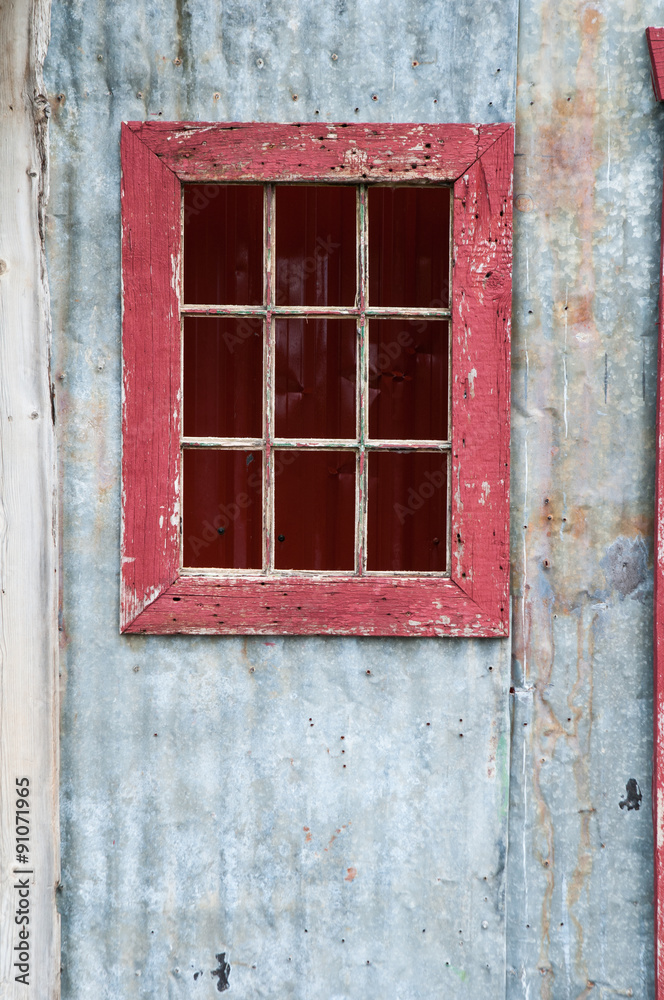 old rustic door with a red window