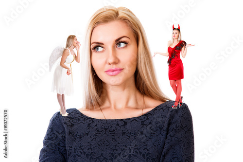 Fototapeta Young woman with small angel and demon on her shoulders