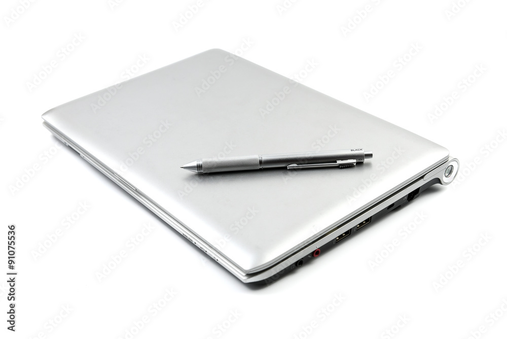 computer laptop and silver pen on white background computer laptop and silver pen on white background