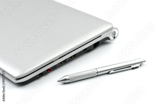 computer laptop and silver pen on white background