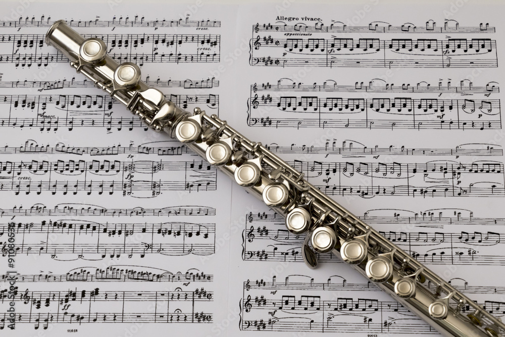 Diagonal flute on flute score music background Stock Photo | Adobe Stock