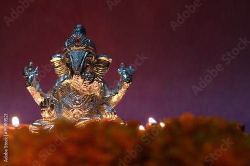 Ganesh idol shining due to oil lamp, festival season
