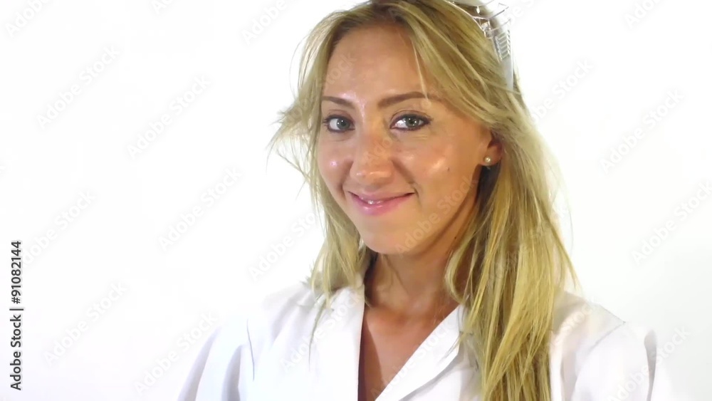 Pretty medical doctor in a white coat woman making hand gesture and send silent lips Pretty medical doctor in a white coat woman making hand gesture and send silent lips