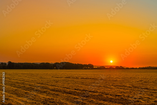 Sunrise over a countryside field