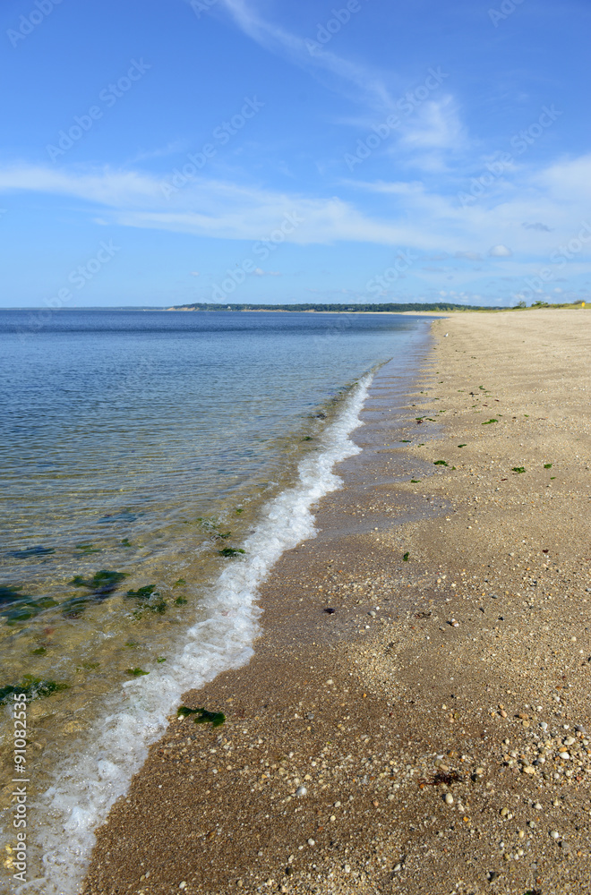 Sand beach on Long Island Sound, with blue skies and no people. New York
