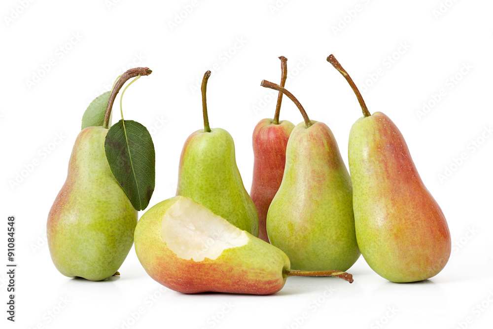 one bitten and a group of sympathizers of green pears on a white one bitten and a group of sympathizers of green pears on a white