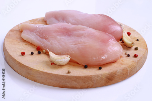 Raw chicken breast fillets on wooden cutting board. Diet food, healthy lifestyle