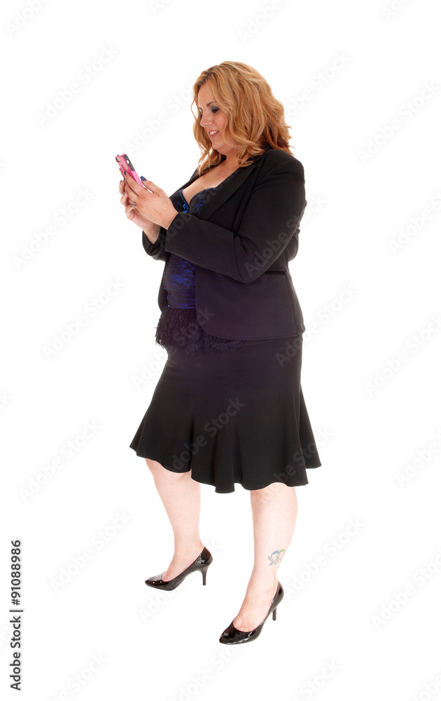 Businesswoman texting on her cellphone. Businesswoman texting on her cellphone.