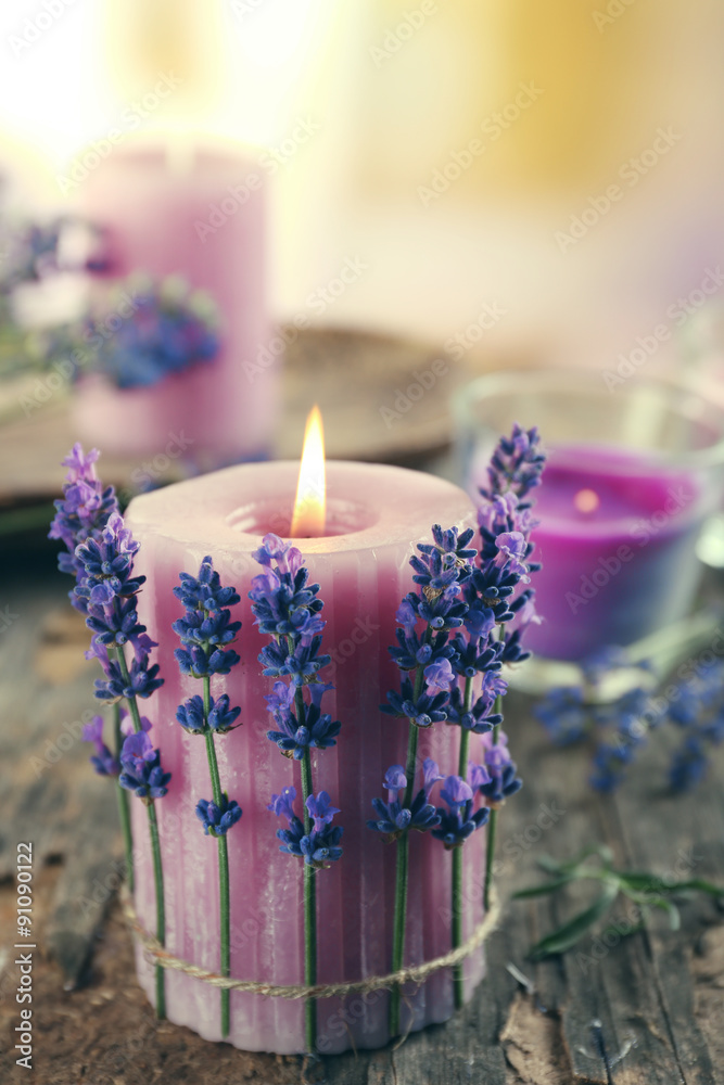 Fototapeta premium Candles with lavender flowers on table close up