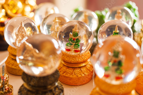 Souvenir for luck - one of buddhism gods in crystal ball. Golden mountain, Bangkok, Thailand. © Konstantin Aksenov