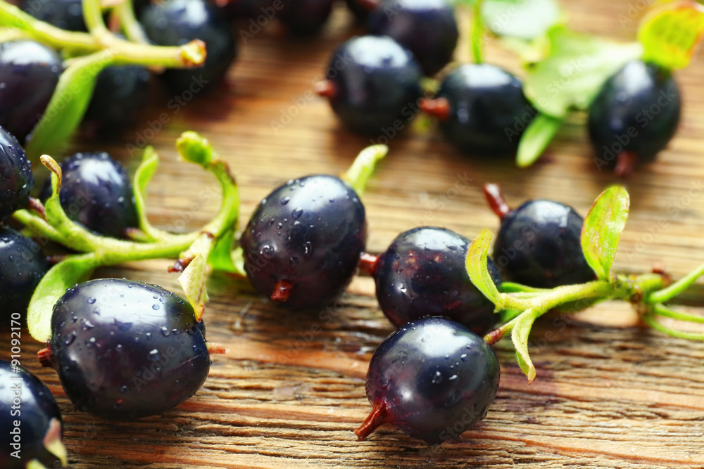 Pile of black currants on wooden table, closeup Pile of black currants on wooden table, closeup