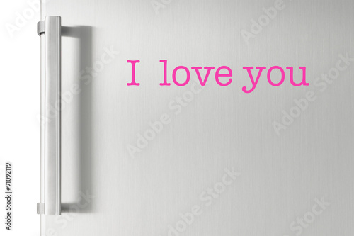 Silver fridge door with handle, with I love you text on it.