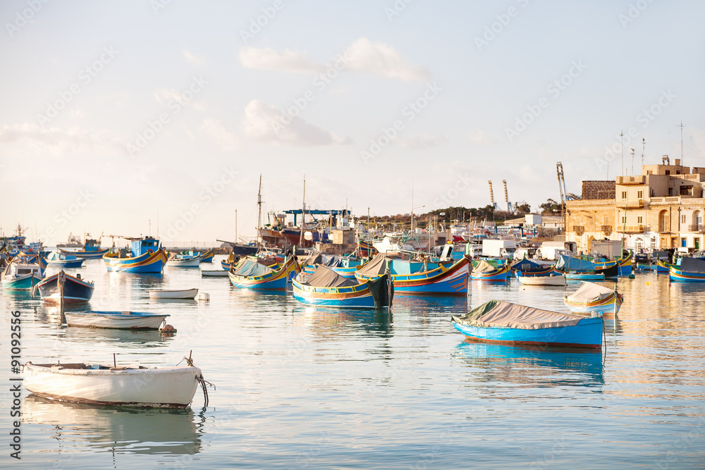 Colorful typical boats in Mediterranean traditional fisherman village. Marsaxlokk, Malta.