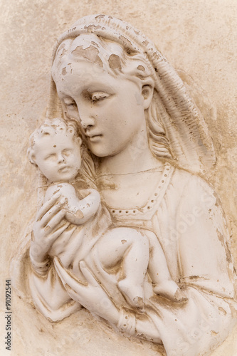 Religious icon (bas-relief) of Madonna with child on a house facade.