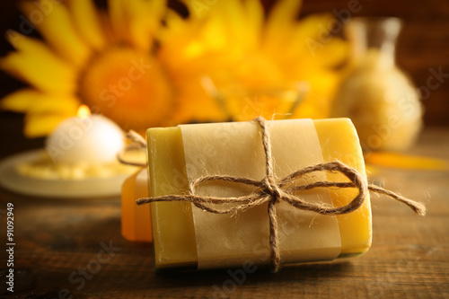 Fototapeta Naklejka Na Ścianę i Meble -  Soap bar and Spa treatments and sunflower on wooden background