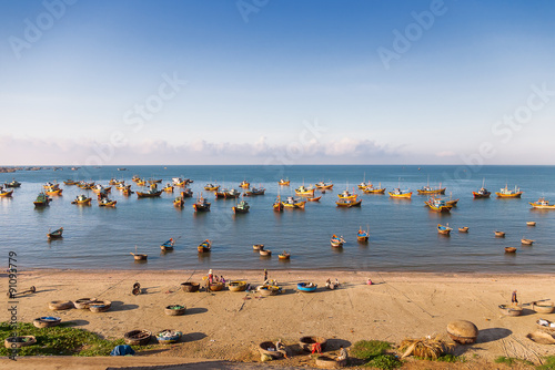 Colorful traditional fishing boats near Mui Ne  Binh Thuan  Vietnam. Early morning  fishermen float to the coast with a catch.