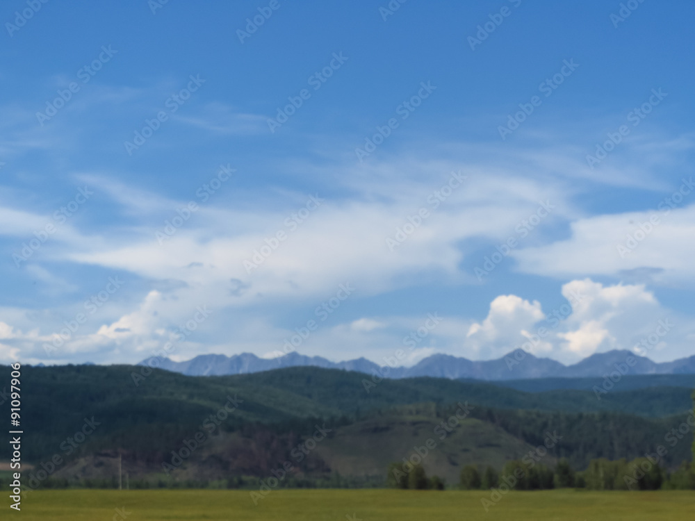 Obraz premium Rocks of mountains are seen because of hills