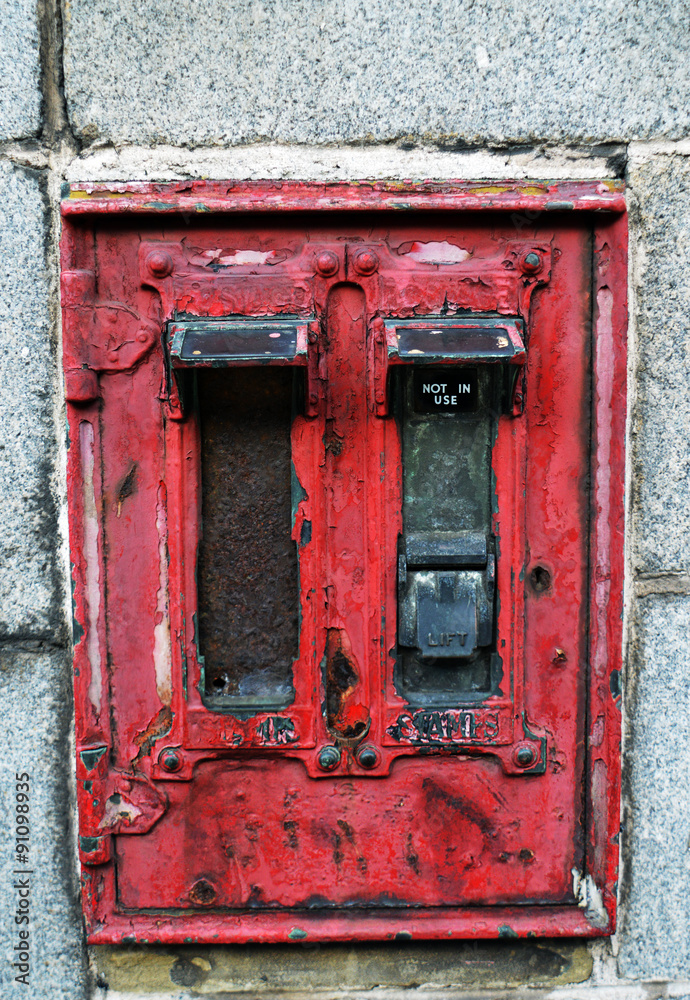 Long-defunct stamp dispenser on granite wall, Aberdeen, Scotland