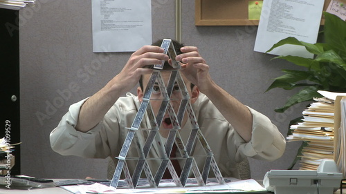 man building house of cards