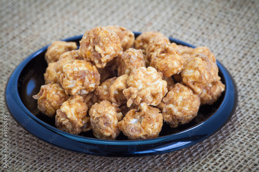 Almond and caramal popcorn on tablecloth background Almond and caramal popcorn on tablecloth background