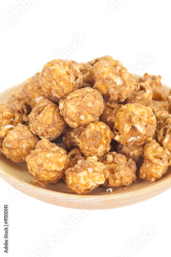 Almond and caramal popcorn on white background
