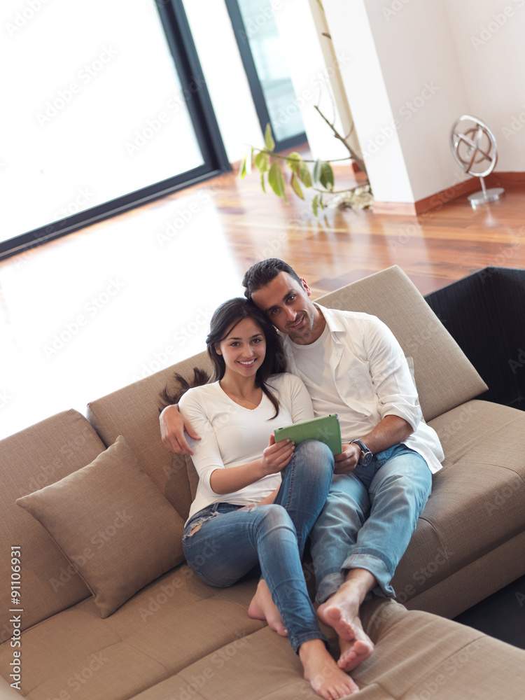 couple at modern home using tablet computer couple at modern home using tablet computer